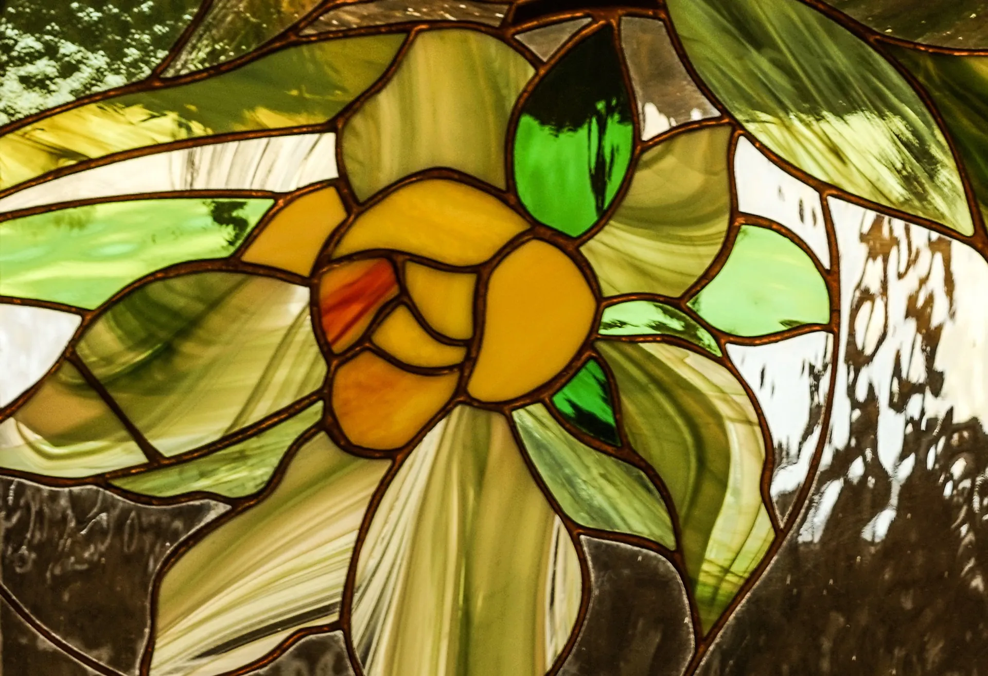 Floral stained glass panel with a yellow flower and green leaves